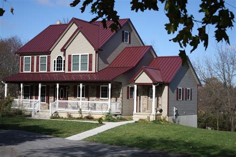 blue house with red metal roof|white house with red roof.